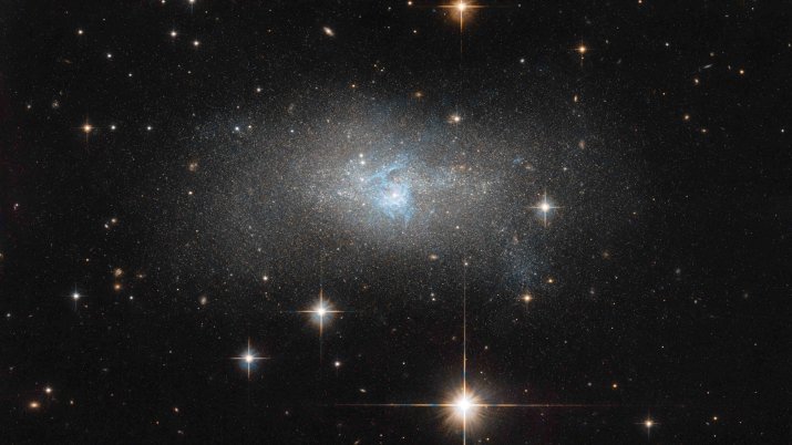Hubble Space Telescope – Distant Galaxy With Bright Blue Cosmic Gas Filaments